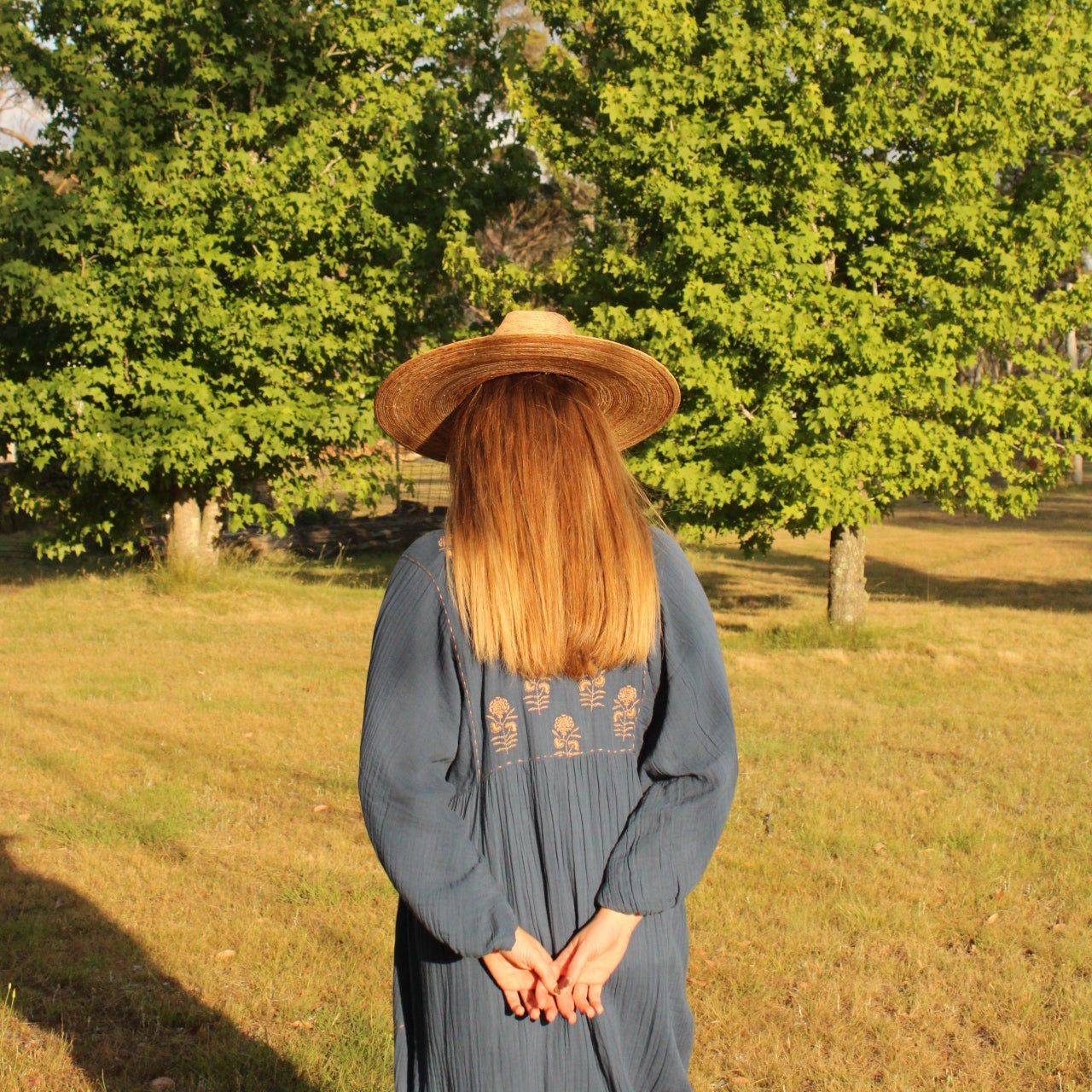 Souq Maxi Dress from Mandalay Designs. Navy dress with drown embroidery details.