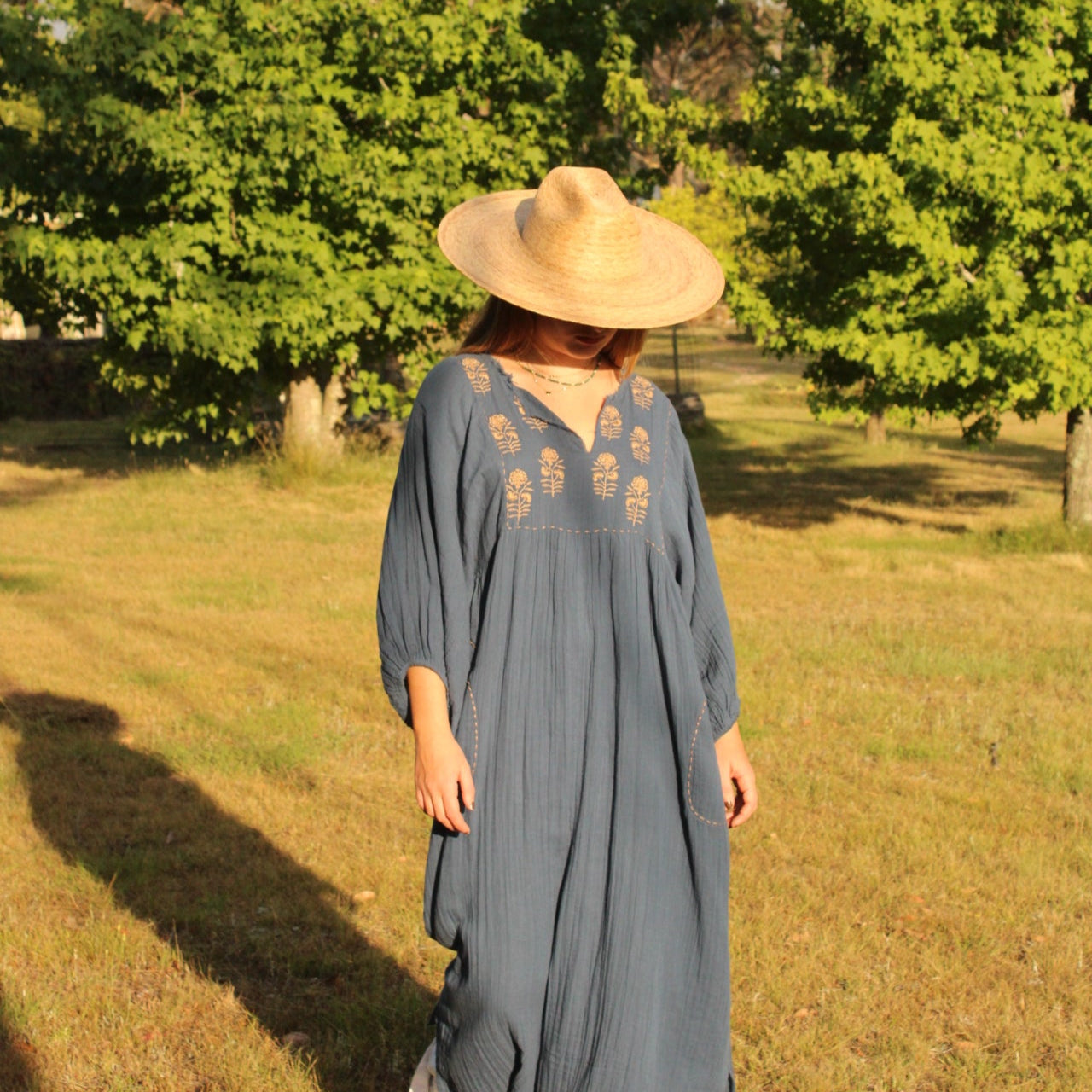 Souq Maxi Dress from Mandalay Designs. Navy dress with drown embroidery details.