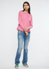 Zaket and Plover's embroided detail jumper in musk, sweater styled casually with jeans and sneakers