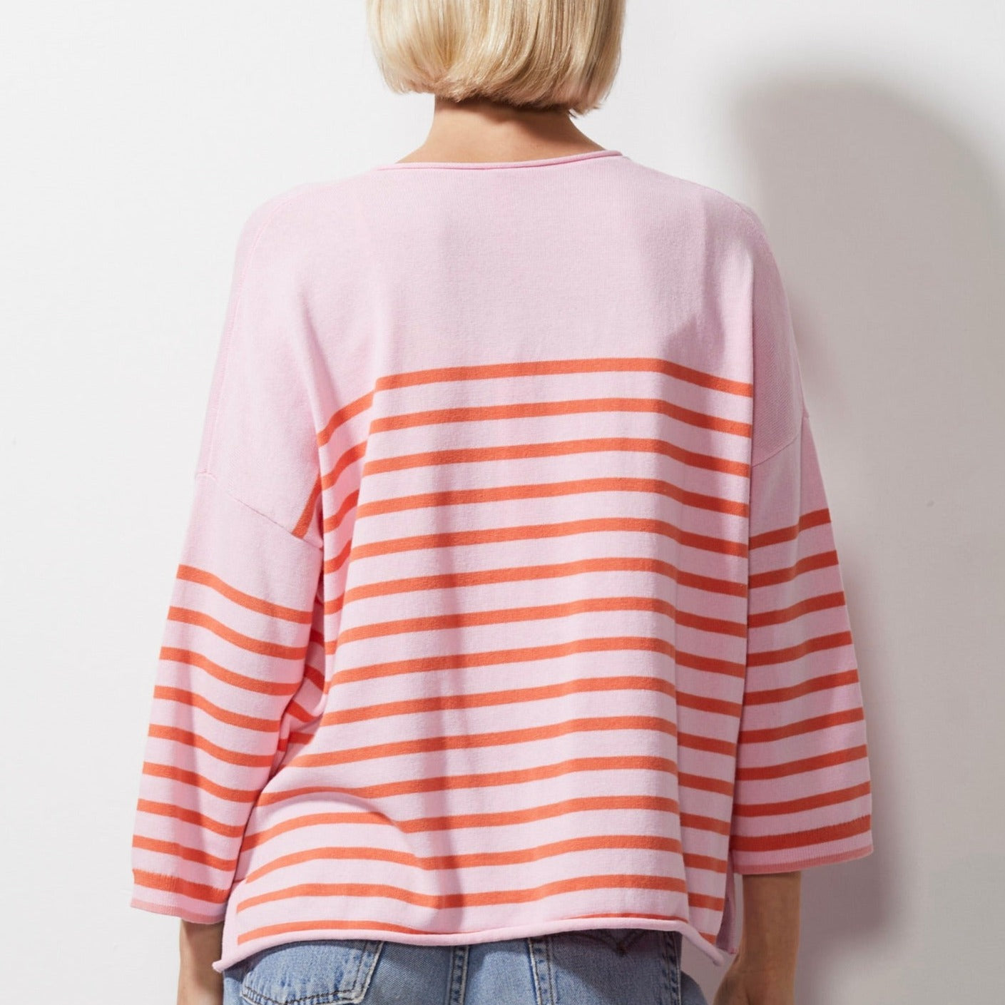 Woman wearing Zaket and Plover's Breton Stripe Vee Jumper in petal