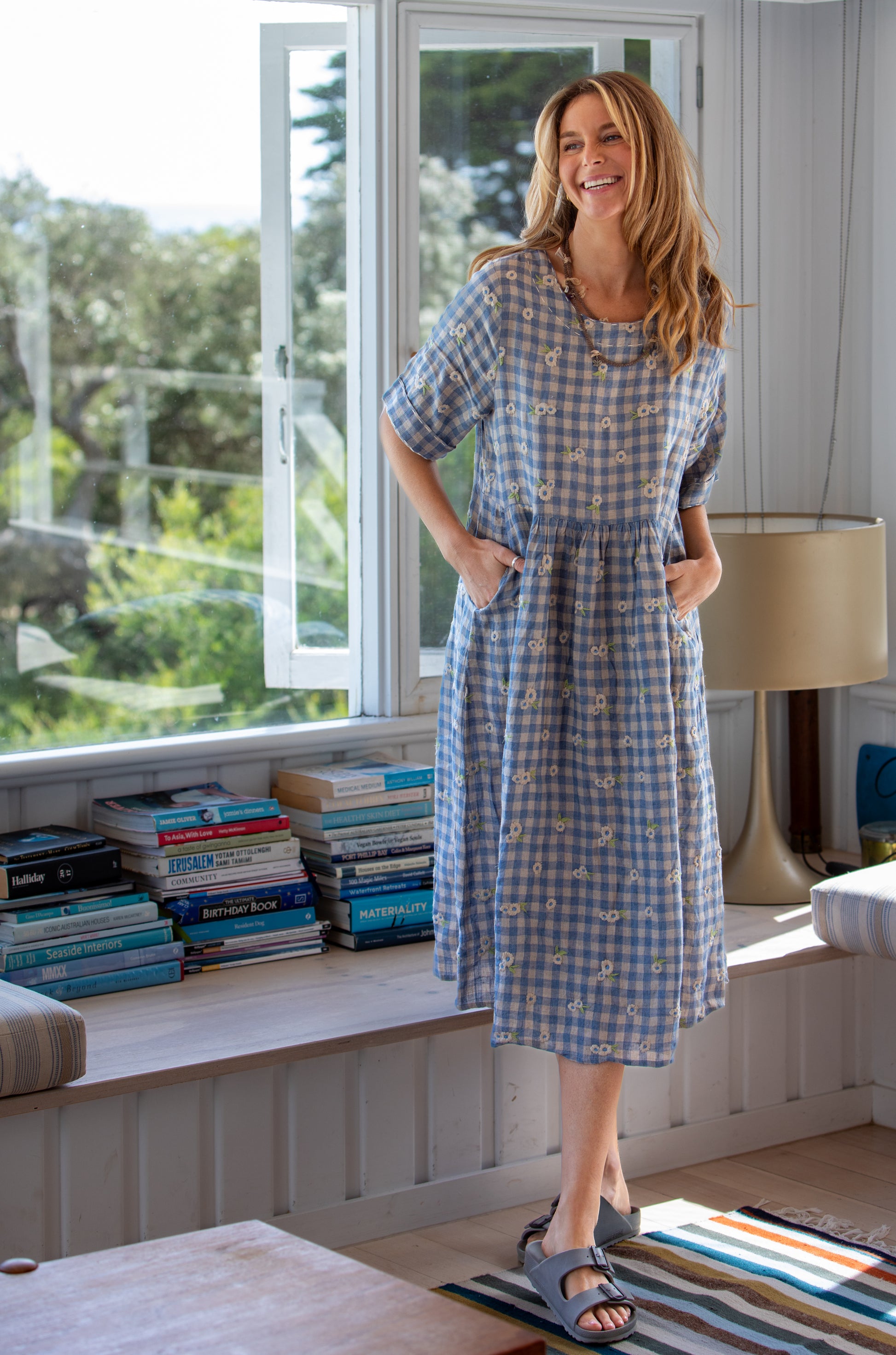 Woman wearing the Mandalay Lee Gingham Flowers linen Dress in Dusty Blue