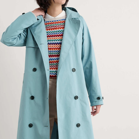 Woman wearing the Penweathers Trench Coat in Hail blue by SEASALT