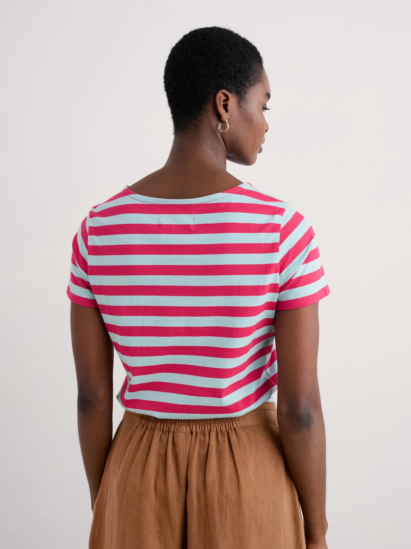 Woman wearing the Sailor striped T-Shirt in Scallion Raspberry by SEASALT