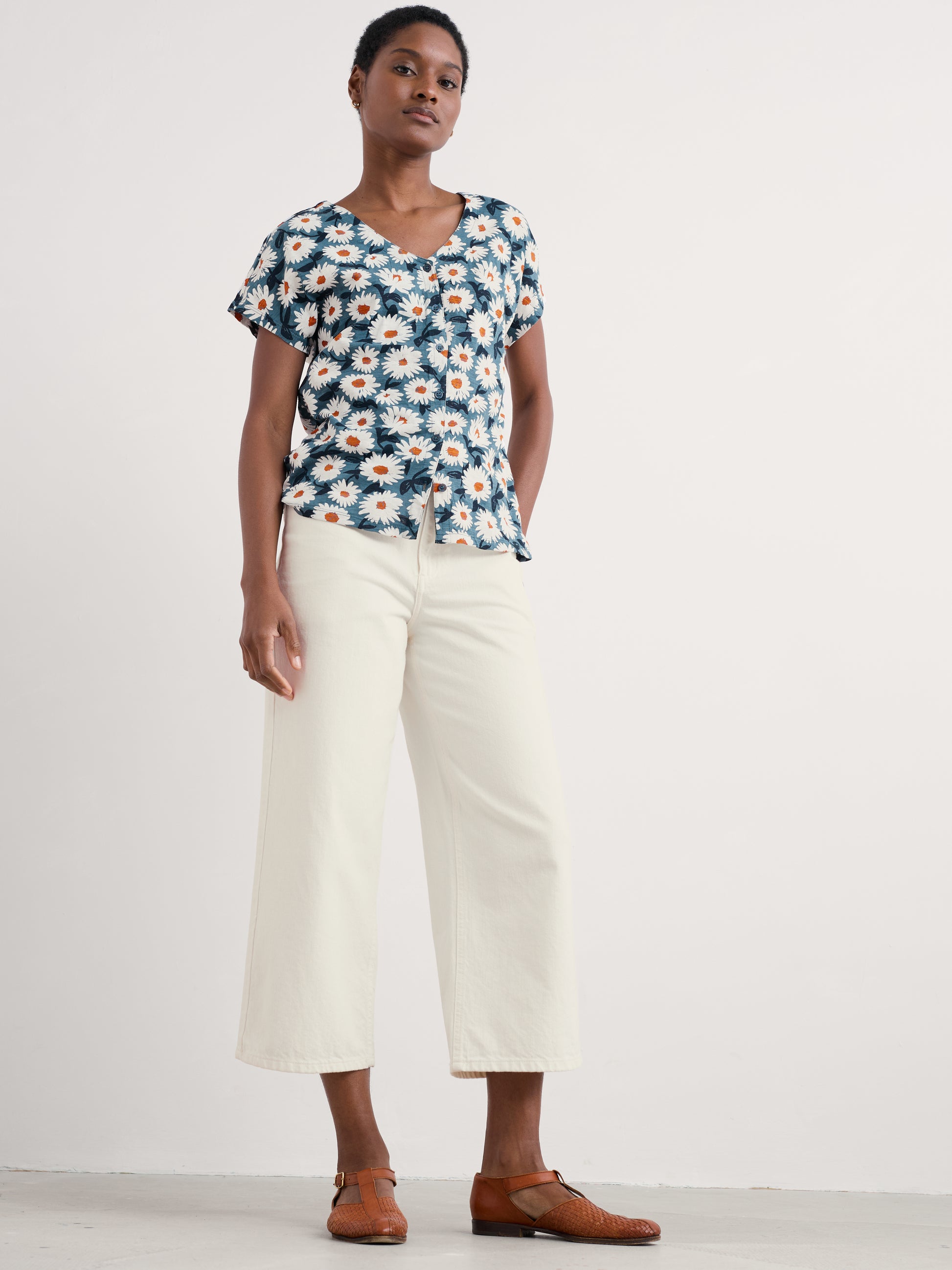 The Studio Glass jersey cotton Top in Artsy Daisy Dusky Jade by SEASALT styled with white jeans