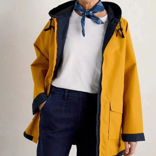 Woman wearing the Reversible Raincoat in Sunglow by SEASALT