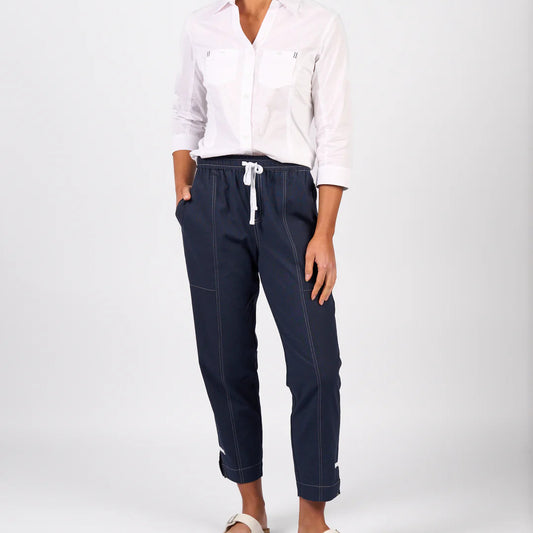 woman wearing the cotton relaxed leg ankle grazer pants with contrast stitching in ink by vassalli