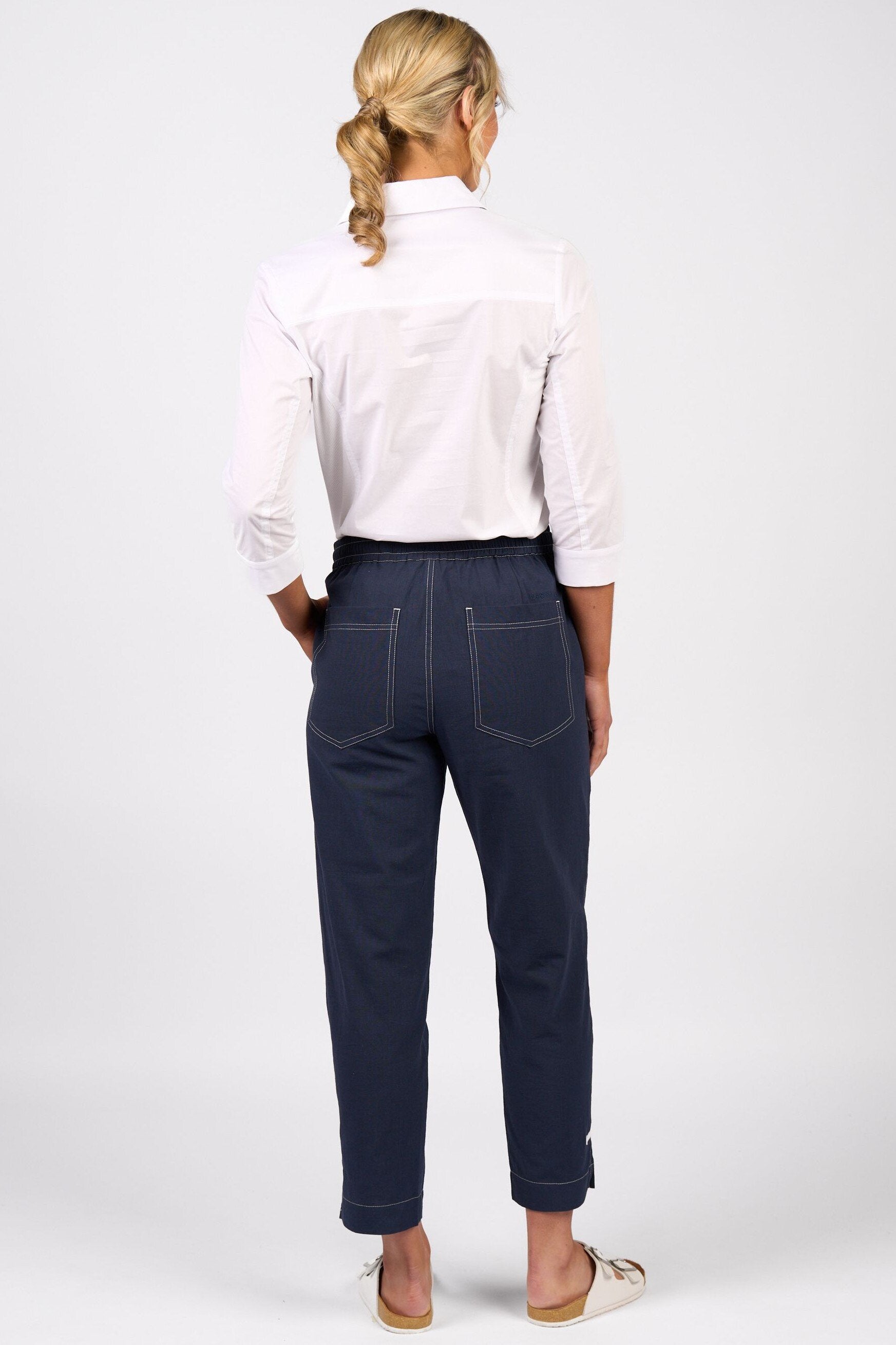 woman wearing the cotton relaxed leg ankle grazer pants with contrast stitching in ink by vassalli