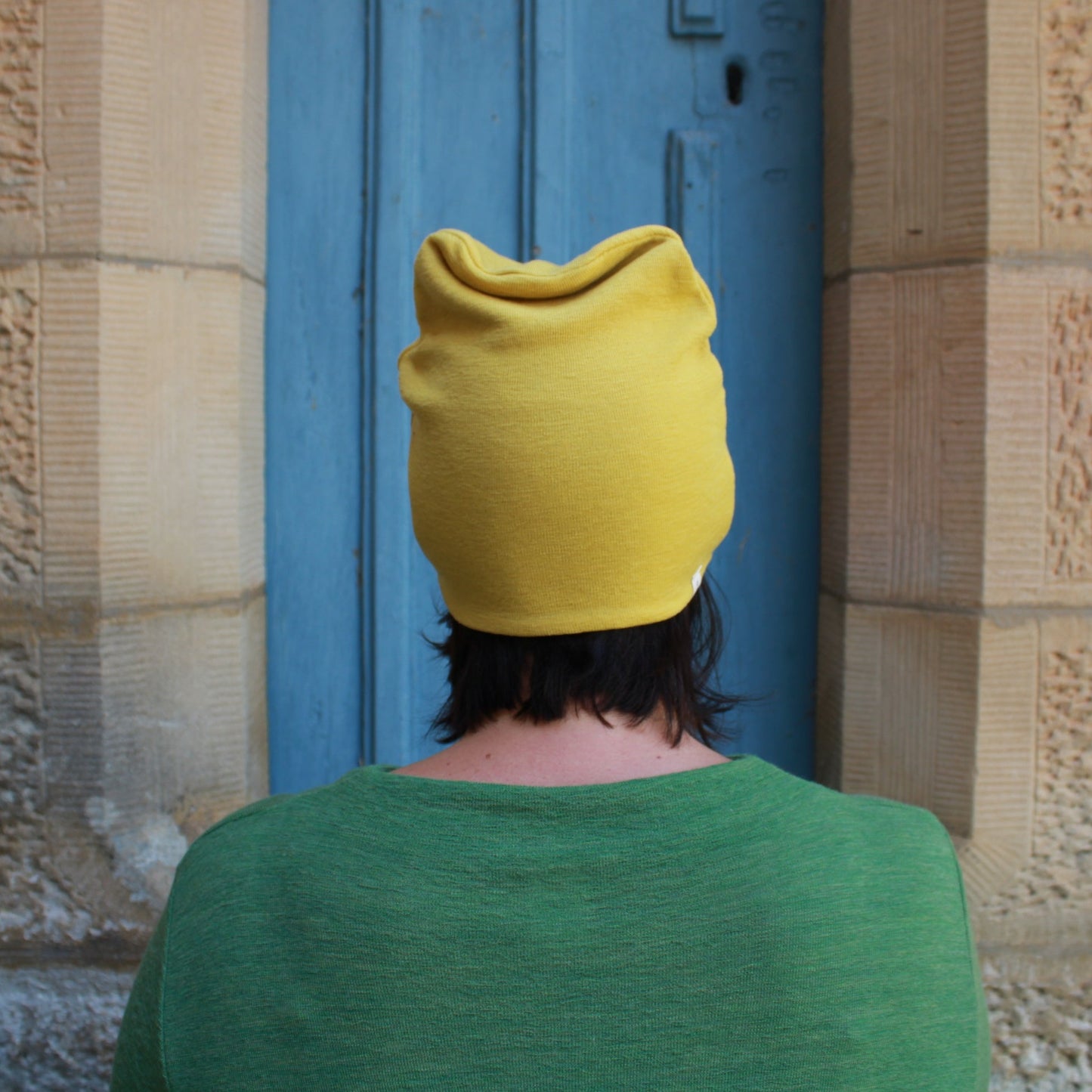 Wool beanie in lemon curry and wool dress in Green. By Basics.