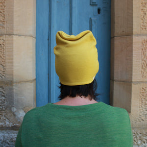 Wool beanie in lemon curry and wool dress in Green. By Basics.