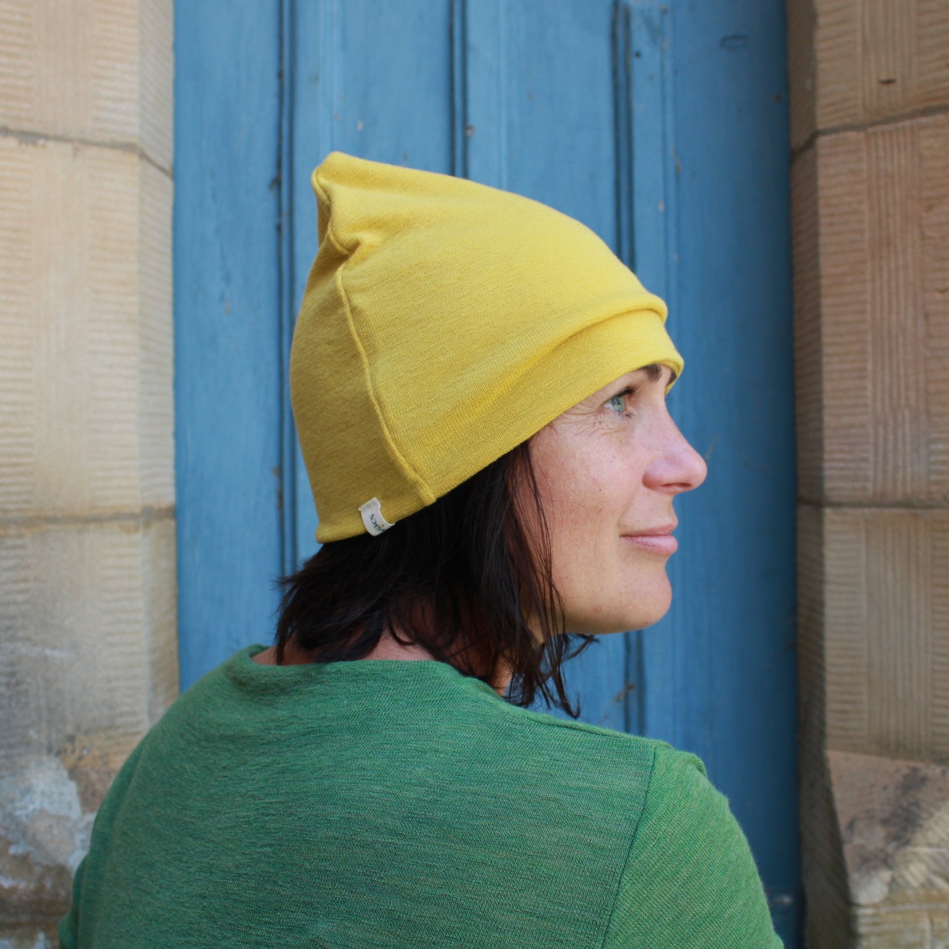 Wool beanie in lemon curry and wool dress in Green. By Basics.