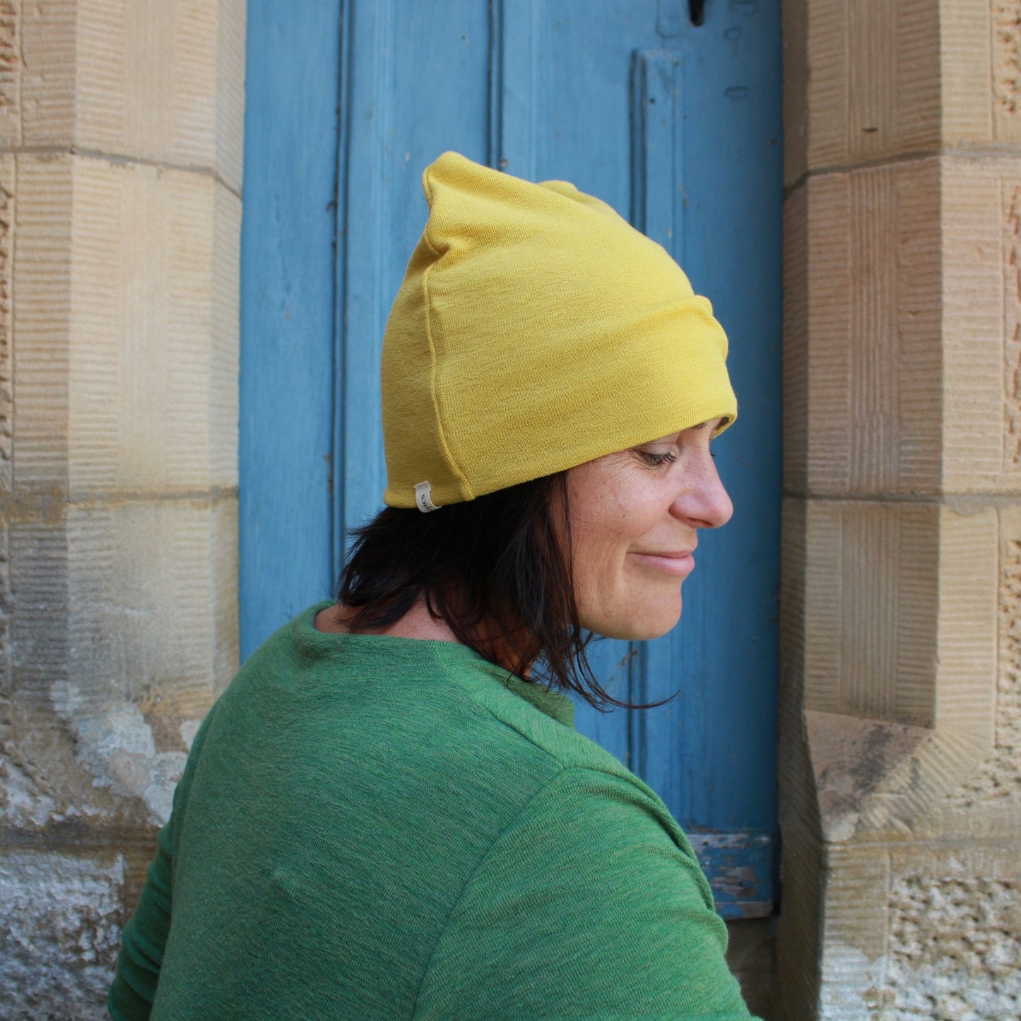 Wool beanie in lemon curry and wool dress in Green. By Basics.