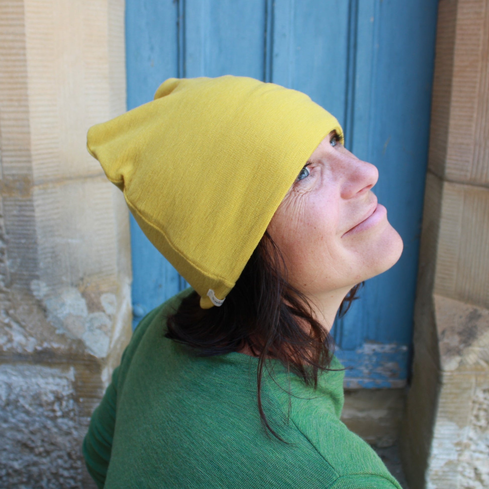 Wool beanie in lemon curry and wool dress in Green. By Basics.