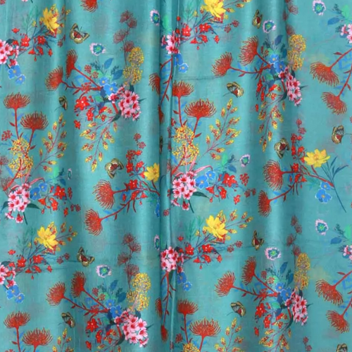 Namaskar Linen Scarf is a vibrant turquoise with flowers