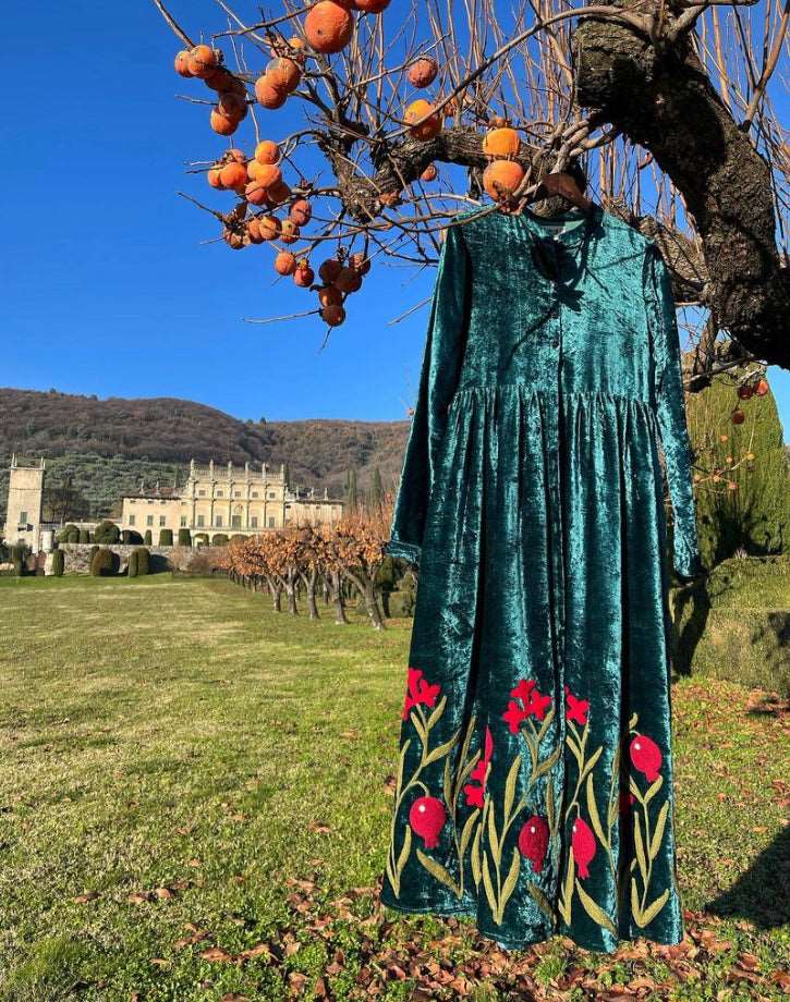 Hand embroidered red flowers on a crushed velvet teal coat dress